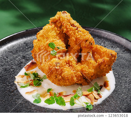 Delicious crispy fried dish served on a black plate 123653018