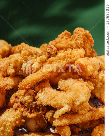 Crispy fried chicken served on a vibrant green backdrop Crispy fried chicken served on a vibrant green backdrop 123653019