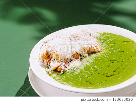 Delicious green soup with crispy bread and cheese topping Delicious green soup with crispy bread and cheese topping 123653020