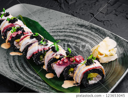 Creative sushi roll presented on an elegant plate with garnish 123653045