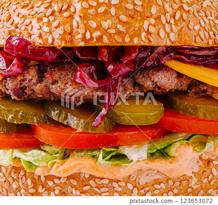 Juicy burger with fresh toppings and sesame bun on wooden table 123653072