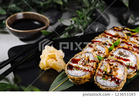 Delectable tempura sushi roll with spicy sauce Delectable tempura sushi roll with spicy sauce 123653165