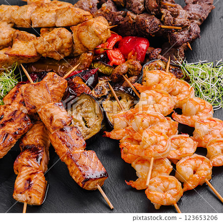 Colorful grilled skewers of shrimp, chicken, and beef 123653206