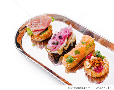 Gourmet canapes served on a silver platter at a stylish event 123653212