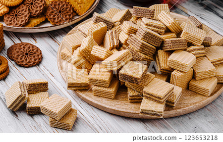 Crunchy wafer snacks arranged on a wooden platter for sharing Crunchy wafer snacks arranged on a wooden platter for sharing 123653218