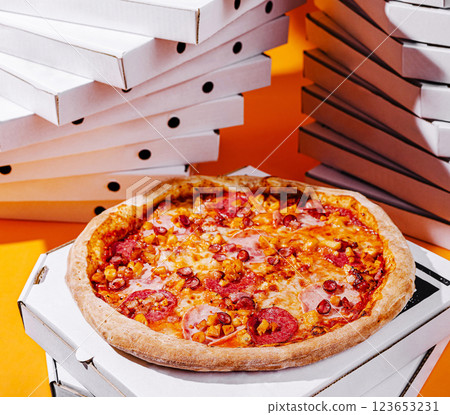 Delicious pizza on a bright orange background with pizza boxes Delicious pizza on a bright orange background with pizza boxes 123653231