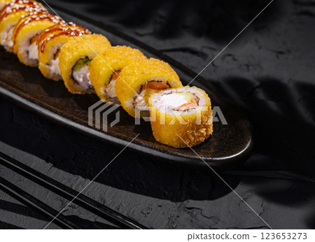Exquisite mango sushi roll on elegant plate Exquisite mango sushi roll on elegant plate 123653273