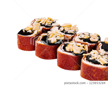 Sweet sushi rolls with chocolate topping and peanuts lying on white background 123653284