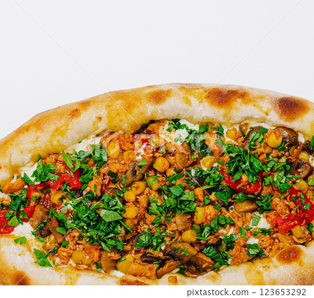 Delicious flatbread topped with savory vegetables and herbs Delicious flatbread topped with savory vegetables and herbs 123653292