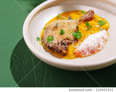 Delicious duck confit served with creamy pumpkin puree Delicious duck confit served with creamy pumpkin puree 123653352