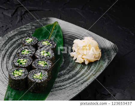 Fresh cucumber sushi rolls served on a decorative plate 123653437