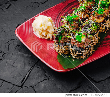 Sushi rolls with fresh toppings served on a vibrant platter Sushi rolls with fresh toppings served on a vibrant platter 123653438