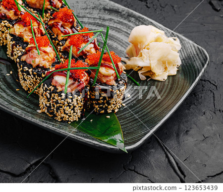 Delicious sushi rolls garnished with seafood and wasabi Delicious sushi rolls garnished with seafood and wasabi 123653439