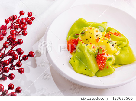 Colorful green pasta dish with roe and sauce garnished beautifully Colorful green pasta dish with roe and sauce garnished beautifully 123653506