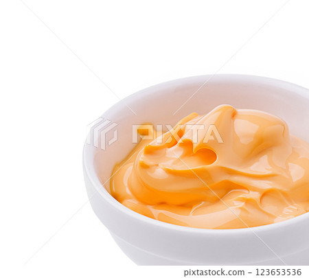 Creamy orange sauce in a white bowl with smooth texture and shine 123653536
