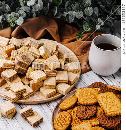 Delicious assortment of cookies and wafers on a rustic table Delicious assortment of cookies and wafers on a rustic table 123653537