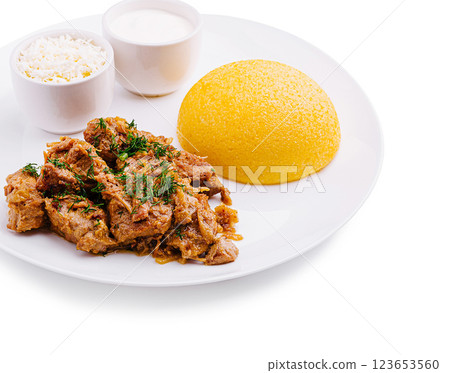 Delicious meal featuring seasoned meat and polenta Delicious meal featuring seasoned meat and polenta 123653560