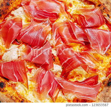 Delicious pizza topped with prosciutto and cheese for a savory treat 123653567