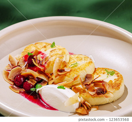 Delicious dessert with pancakes, cream, and berries served elegantly Delicious dessert with pancakes, cream, and berries served elegantly 123653568