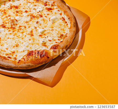 Freshly baked cheese pizza on a yellow background 123653587