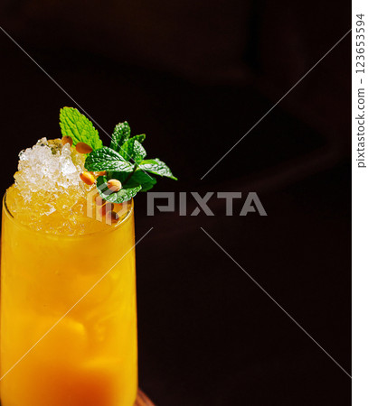 Refreshing tropical cocktail topped with mint and pine nuts Refreshing tropical cocktail topped with mint and pine nuts 123653594