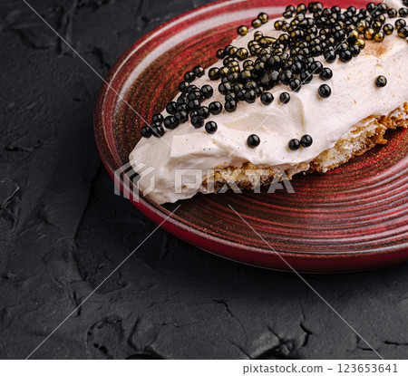 Delicious dessert topping with black pearls on a pastry plate Delicious dessert topping with black pearls on a pastry plate 123653641