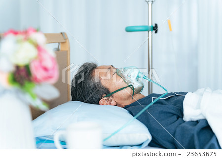 Senior man sleeping on bed with oxygen tube 123653675
