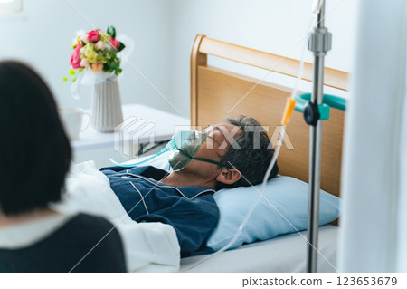A woman watching over a hospital patient 123653679