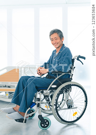 Smiling senior man sitting in a wheelchair 123653684
