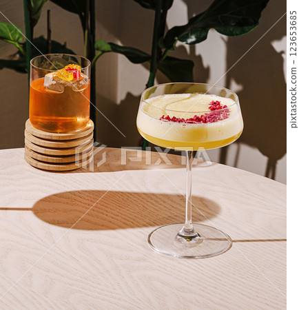 Colorful cocktails served on a wooden table with foliage backdrop Colorful cocktails served on a wooden table with foliage backdrop 123653685