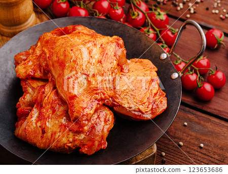 Grilled marinated chicken thighs in rustic kitchen 123653686