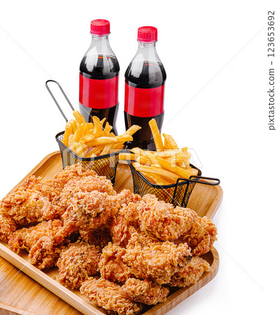 Crispy fried chicken served with fries and soft drinks in baskets 123653692