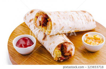 Freshly made wraps with meat and fries on a wooden plate 123653718