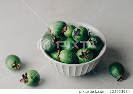 Bowl of feijoa fruits on concrete background Bowl of feijoa fruits on concrete background 123653984
