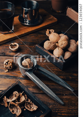 Walnuts and nutcracker on table 123654007