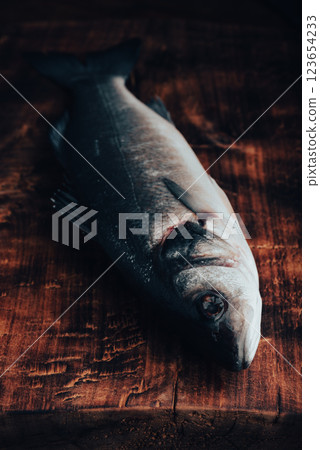 Freshly Caught Sea Bass on Wooden Surface 123654233