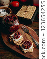Crackers with cream cheese and sundried tomatoes 123654255