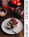 Toast with cream cheese and sundried tomatoes on plate 123654258