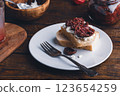 Toast with cream cheese and sundried tomatoes on plate 123654259