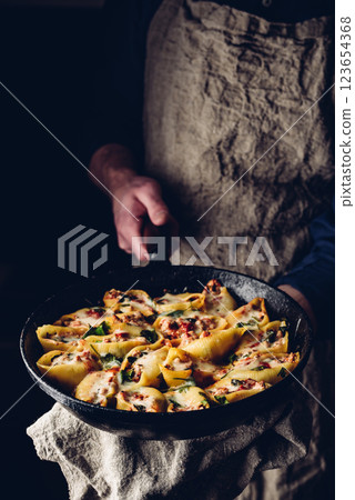 Skillet of pasta stuffed with ground beef, spinach and cheese 123654368