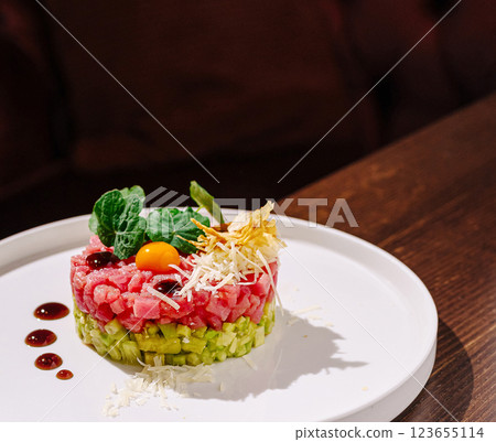 Colorful dish of finely chopped ingredients served on a white plate Colorful dish of finely chopped ingredients served on a white plate 123655114