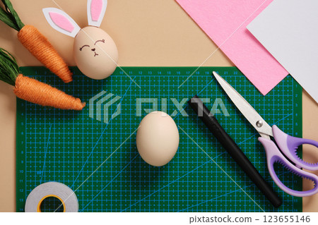 DIY Easter Bunny Egg Craft. Step-by-step instructions. Step 1. Take an egg, light-colored paper, pink paper or fabric, felt-tip pen and double-sided tape, scissors DIY Easter Bunny Egg Craft. Step-by-step instructions. Step 1. Take an egg, light-colored paper, pink paper or fabric, felt-tip pen and double-sided tape, scissors 123655146