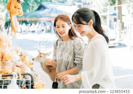 A woman (friend) visiting a souvenir shop in Nara 123655455