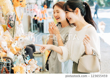 A woman (friend) visiting a souvenir shop in Nara 123655459