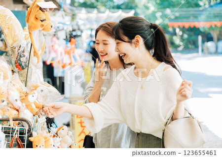 A woman (friend) visiting a souvenir shop in Nara 123655461