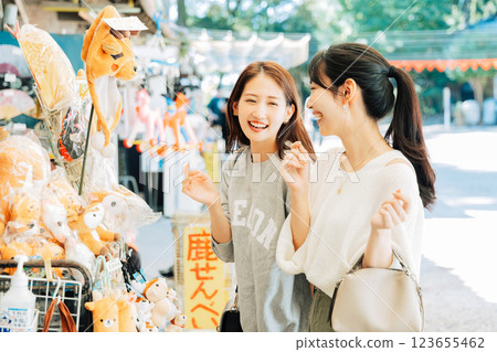 A woman (friend) visiting a souvenir shop in Nara A woman (friend) visiting a souvenir shop in Nara 123655462
