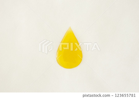 Oil drop on baking paper. Yellow body oil or cooking oil minimal. Cooking with less oil. 123655781