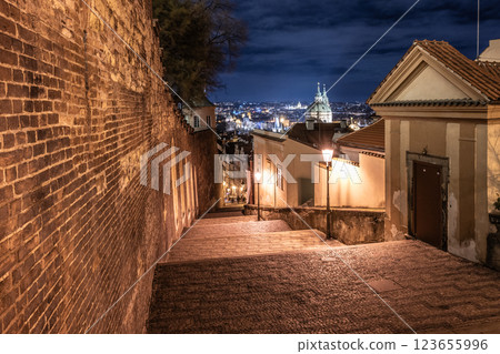 Step down the beautifully lit staircase of Prague Castle at night, offering stunning views of the city skyline. The serene atmosphere invites exploration and reflection. Step down the beautifully lit staircase of Prague Castle at night, offering stunning views of the city skyline. The serene atmosphere invites exploration and reflection. 123655996
