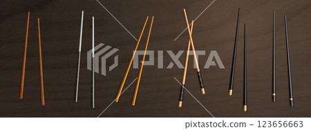 Realistic chopsticks collection on dark table 123656663