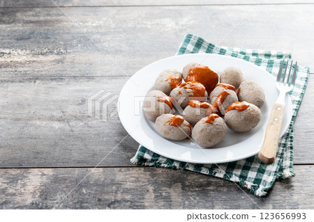 Papas arrugadas with mojo on wooden table. Traditional Canary Islands food. Papas arrugadas with mojo on wooden table. Traditional Canary Islands food. 123656993
